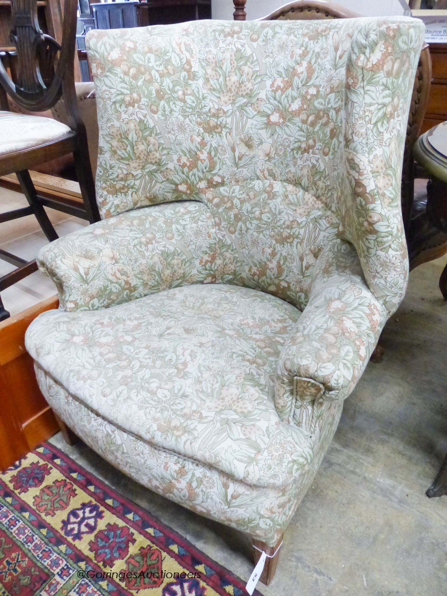 A George III upholstered tub framed wing armchair, width 80cm, depth 60cm, height 102cm