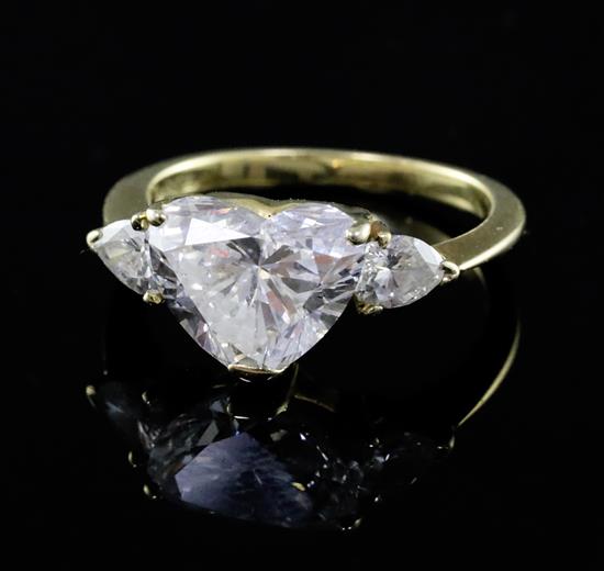 A 1980s Kutchinsky 18ct gold heart shaped diamond set dress ring with pear cut diamond set shoulders, size J. A 1980s Kutchinsky 18ct gold heart shaped diamond set dress ring with pear cut diamond set shoulders, size J.