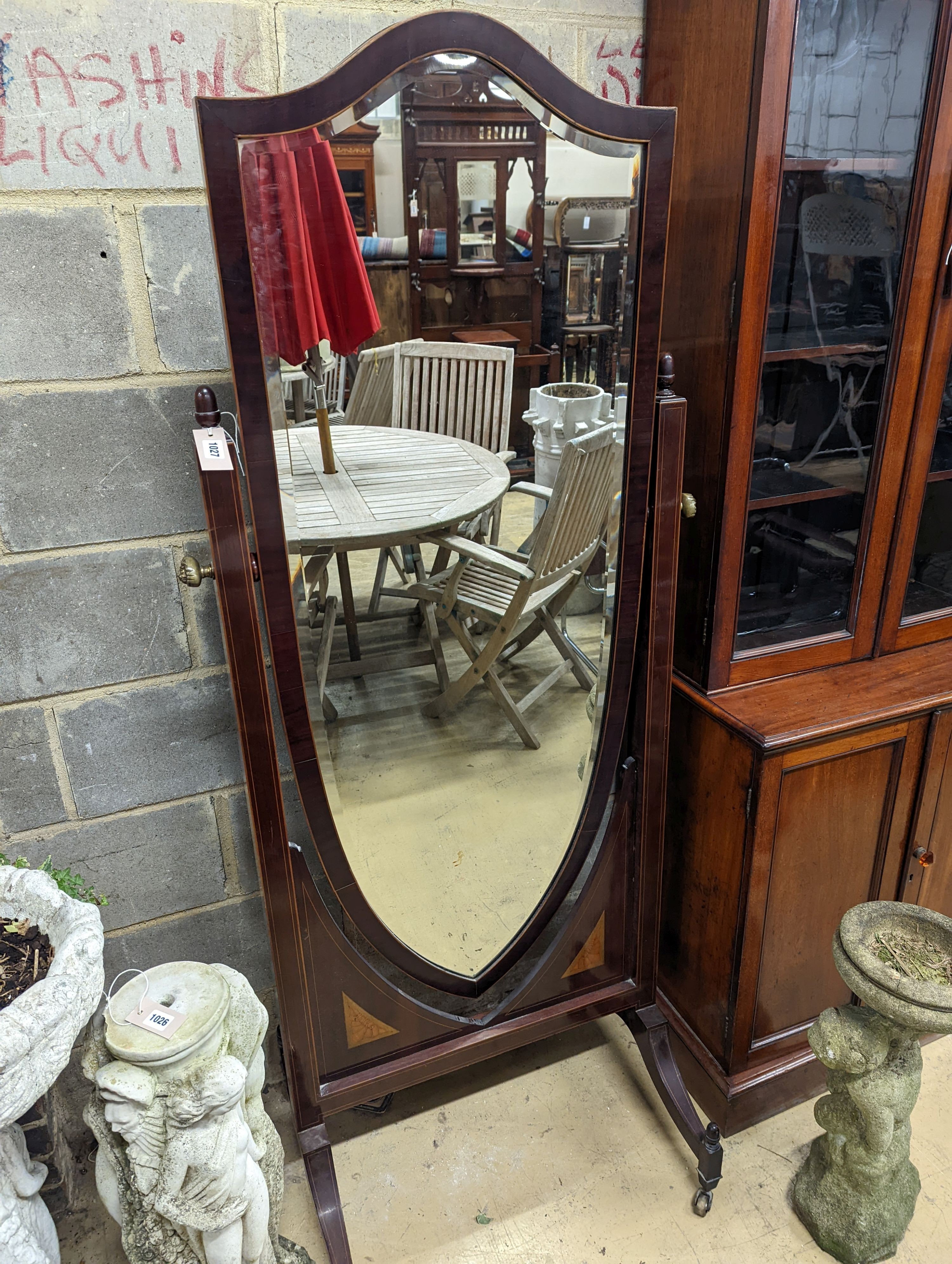 An Edwardian inlaid mahogany cheval mirror with shield shape plate, width 75cm, height 177cm
