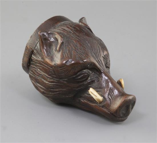A late 18th century carved treen stirrup cup, modelled as a boars head with inset tusks, 4.5in. A late 18th century carved treen stirrup cup, modelled as a boars head with inset tusks, 4.5in.