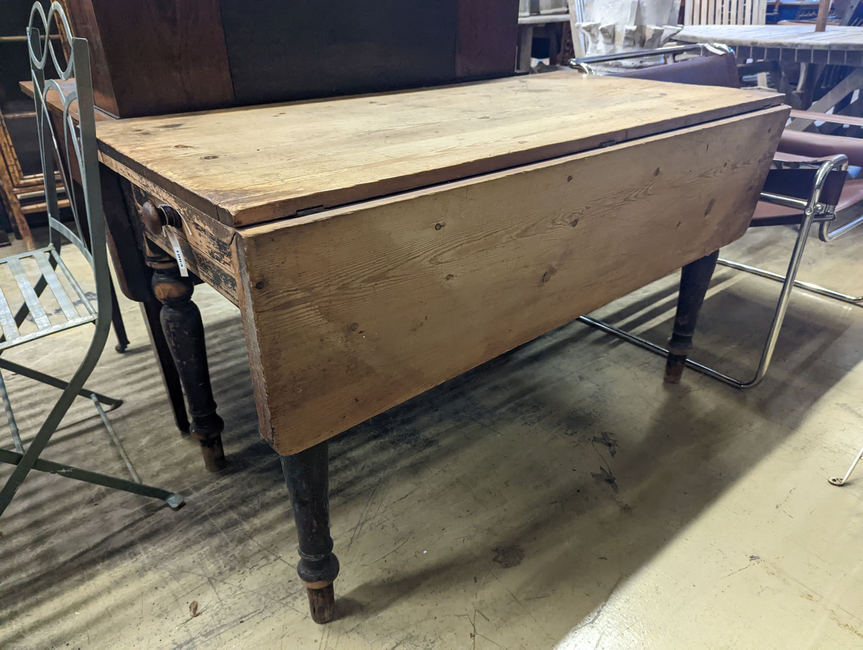 A Victorian pine drop flap kitchen table fitted drawer, width 122cm, length 117cm extended, height 70cm