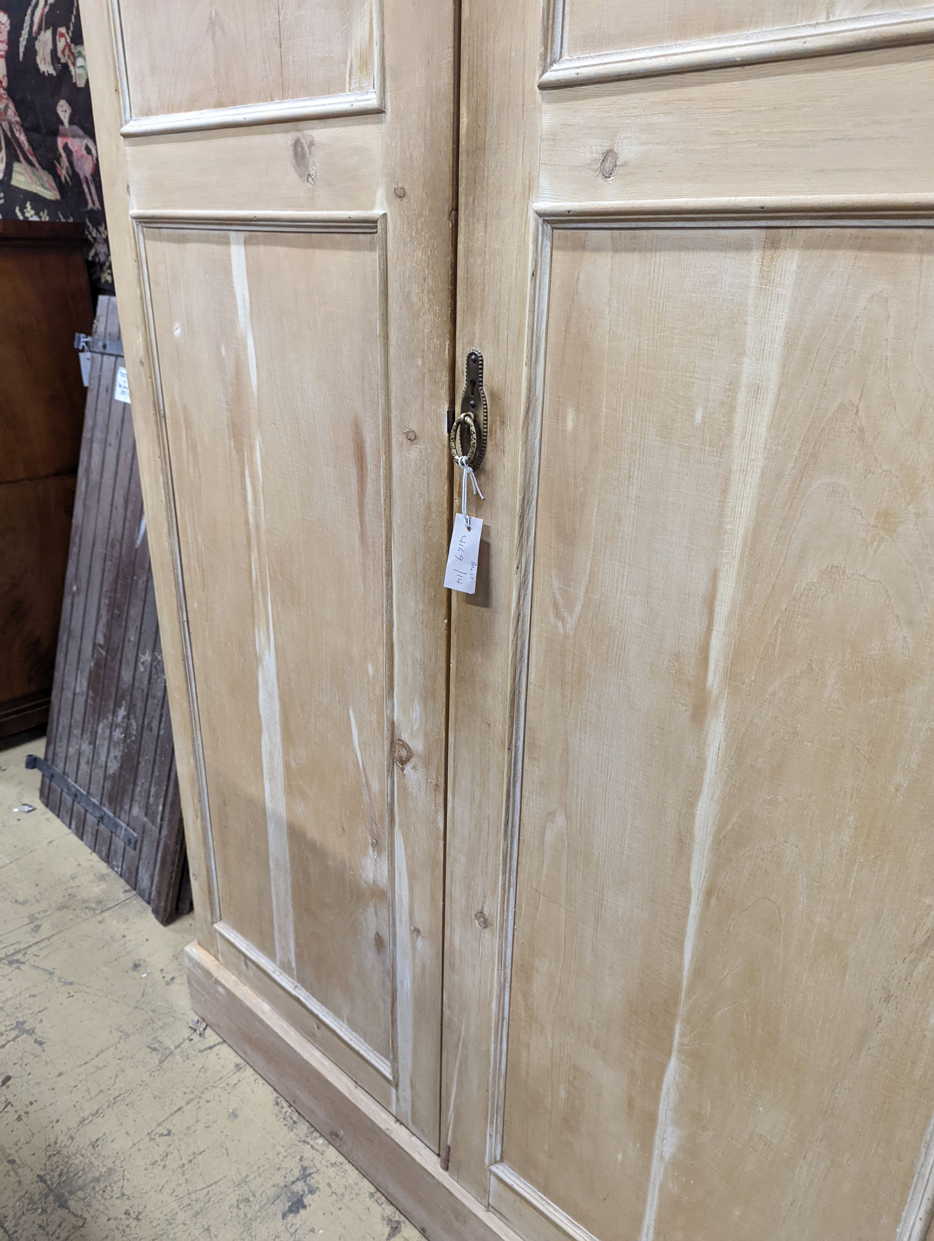 An early 20th century stripped pine two door press cupboard, width 120cm, depth 52cm