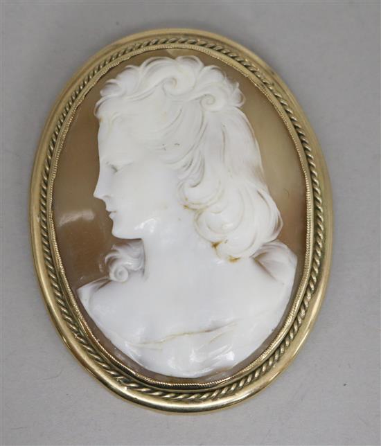A 9ct gold framed shell cameo brooch, A 9ct gold framed shell cameo brooch,
