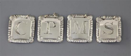 A set of four George III silver wine labels by John Reily, 4cm. A set of four George III silver wine labels by John Reily, 4cm.