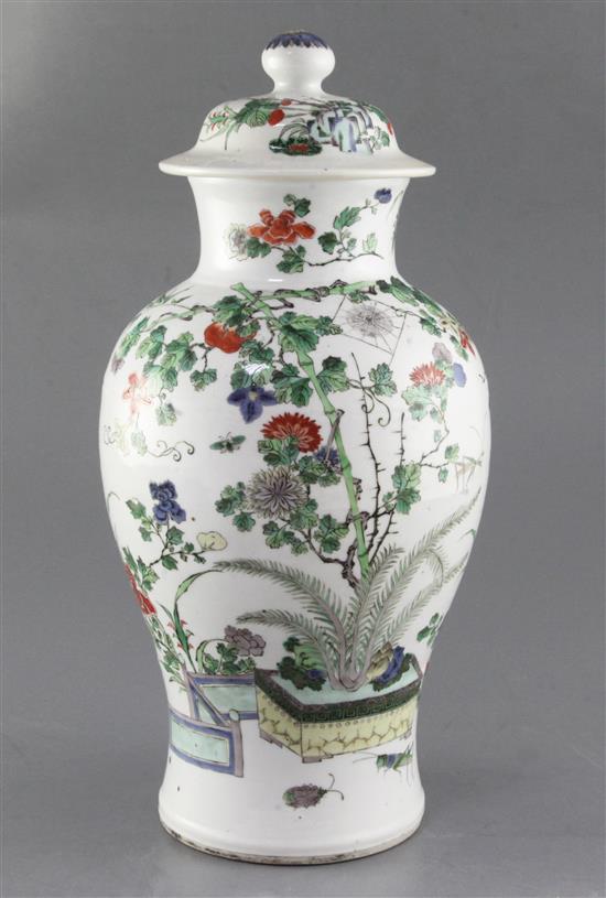 A Chinese famille verte vase and cover, late 19th century, height 37.5cm, hairline crack to rim, wood stand A Chinese famille verte vase and cover, late 19th century, height 37.5cm, hairline crack to rim, wood stand