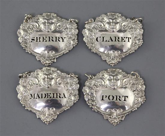 A set of four George III silver wine labels by Charles Rawlings, 56mm. A set of four George III silver wine labels by Charles Rawlings, 56mm.