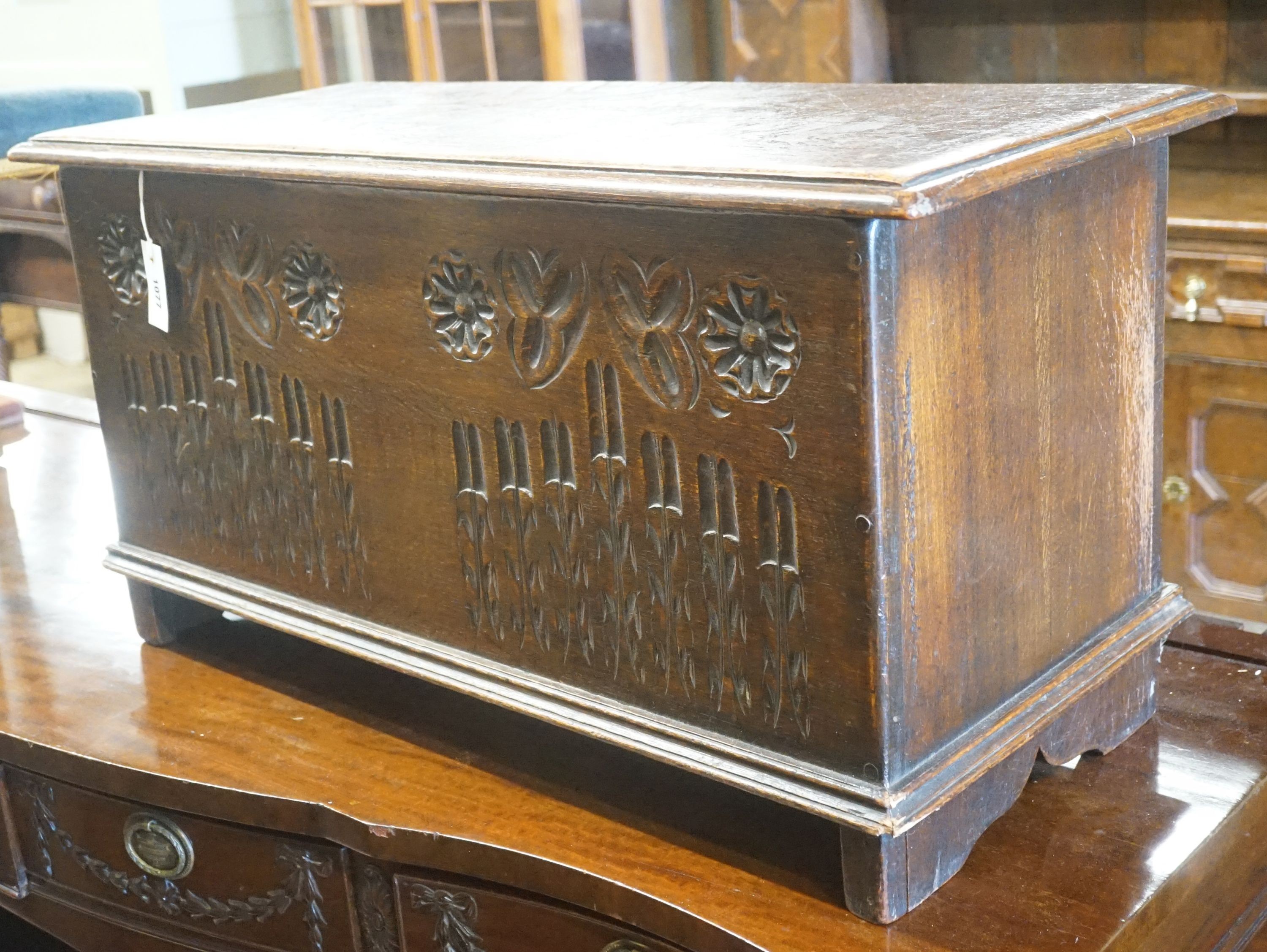 A small 17th century style carved country oak coffer, width 91cm depth 40cm height 47cm