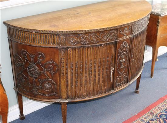 A Georgian style mahogany demi-lune sideboard W.137cm A Georgian style mahogany demi-lune sideboard W.137cm