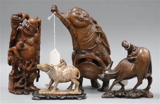 Three Chinese figural wood carvings and a soapstone carving of a child riding a water buffalo, Three Chinese figural wood carvings and a soapstone carving of a child riding a water buffalo,