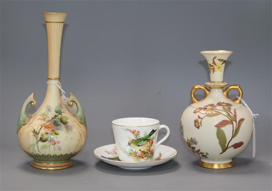 A Royal Worcester blush ivory vase, an ivory ground vase, and a Worcester China Decorators bird painted cup and saucer tallest 25cm
