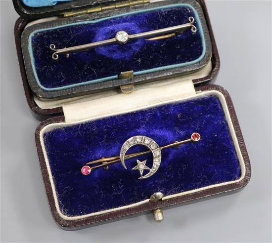 Two early 20th century yellow metal and diamond set bar brooches including crescent and star. Two early 20th century yellow metal and diamond set bar brooches including crescent and star.