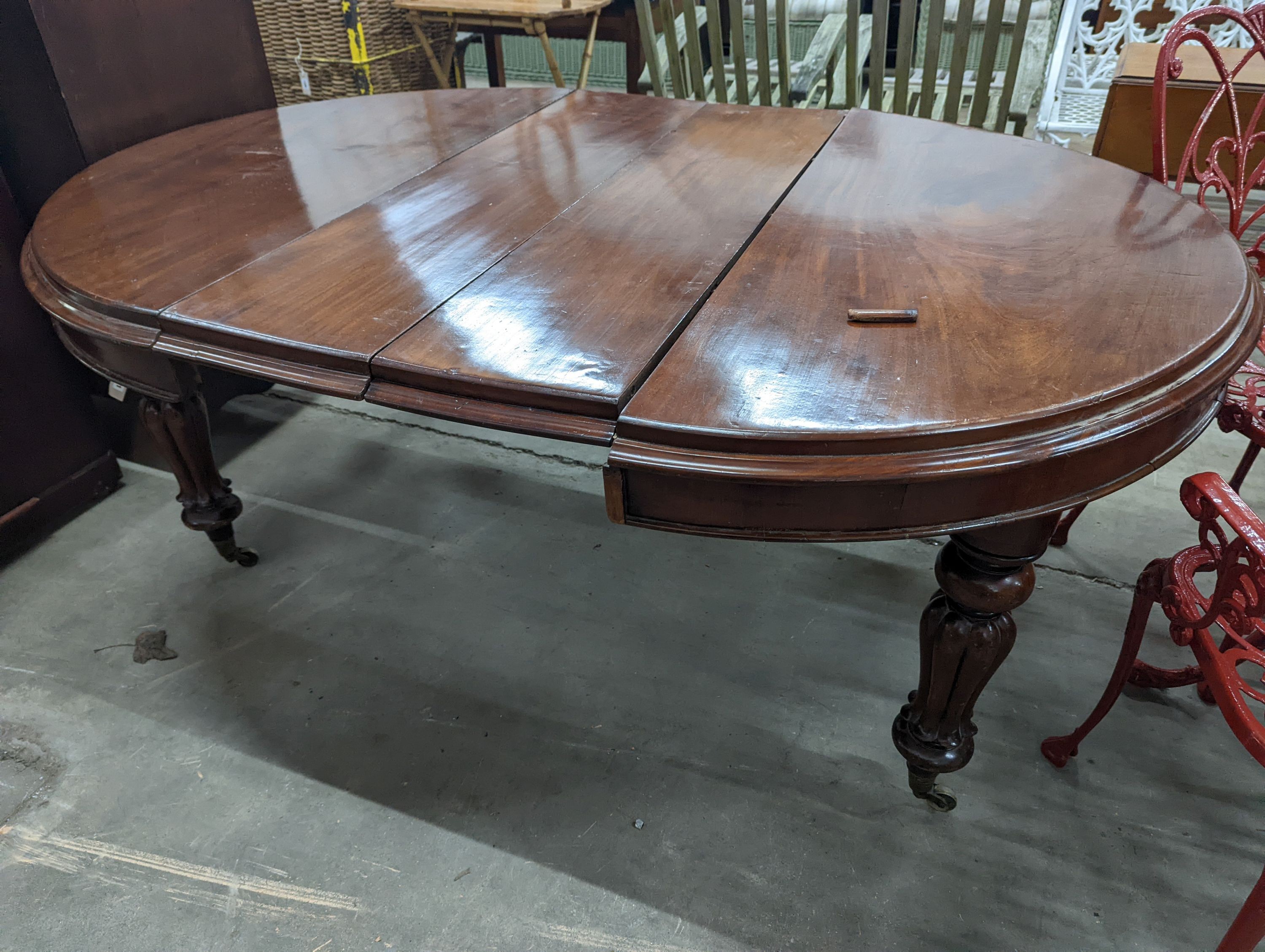 A Victorian mahogany extending dining table, length 170cm extended (two spare leaves), width 119cm, height 71cm