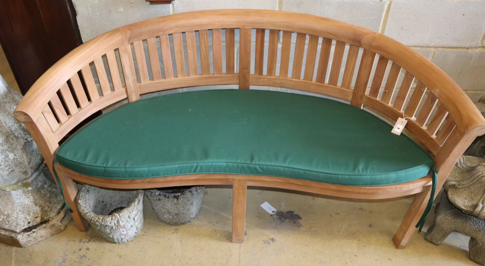 a teak garden banana bench with cushion seat, w.160cm, d