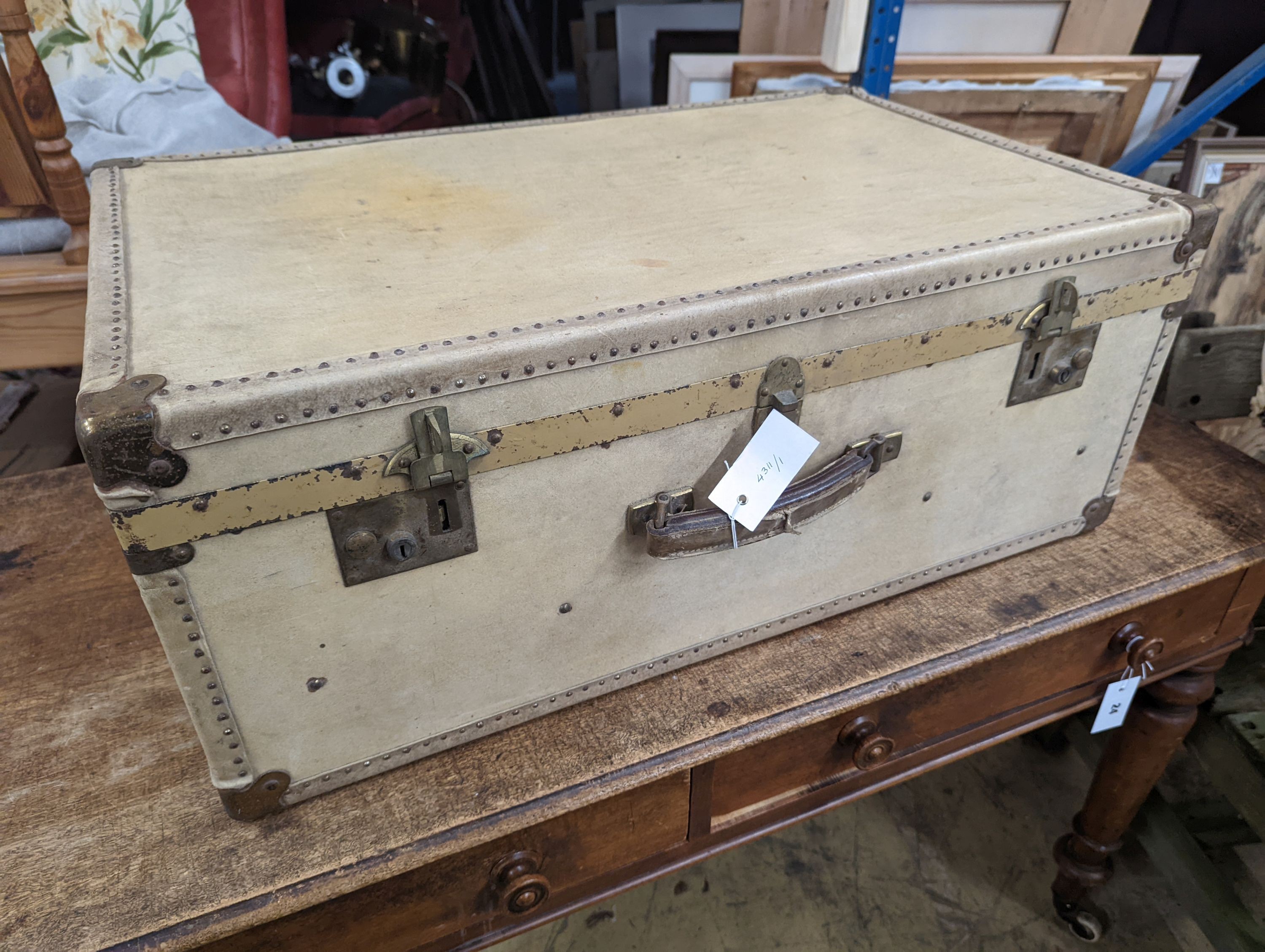 An early 20th century brass mounted vellum suitcase, length 75cm, depth 48cm, height 30cm