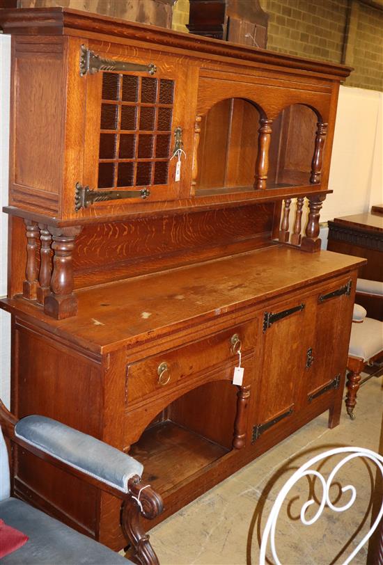 An Arts & Crafts oak raised back sideboard, W.176cm, D.54cm, H.185cm An Arts & Crafts oak raised back sideboard, W.176cm, D.54cm, H.185cm