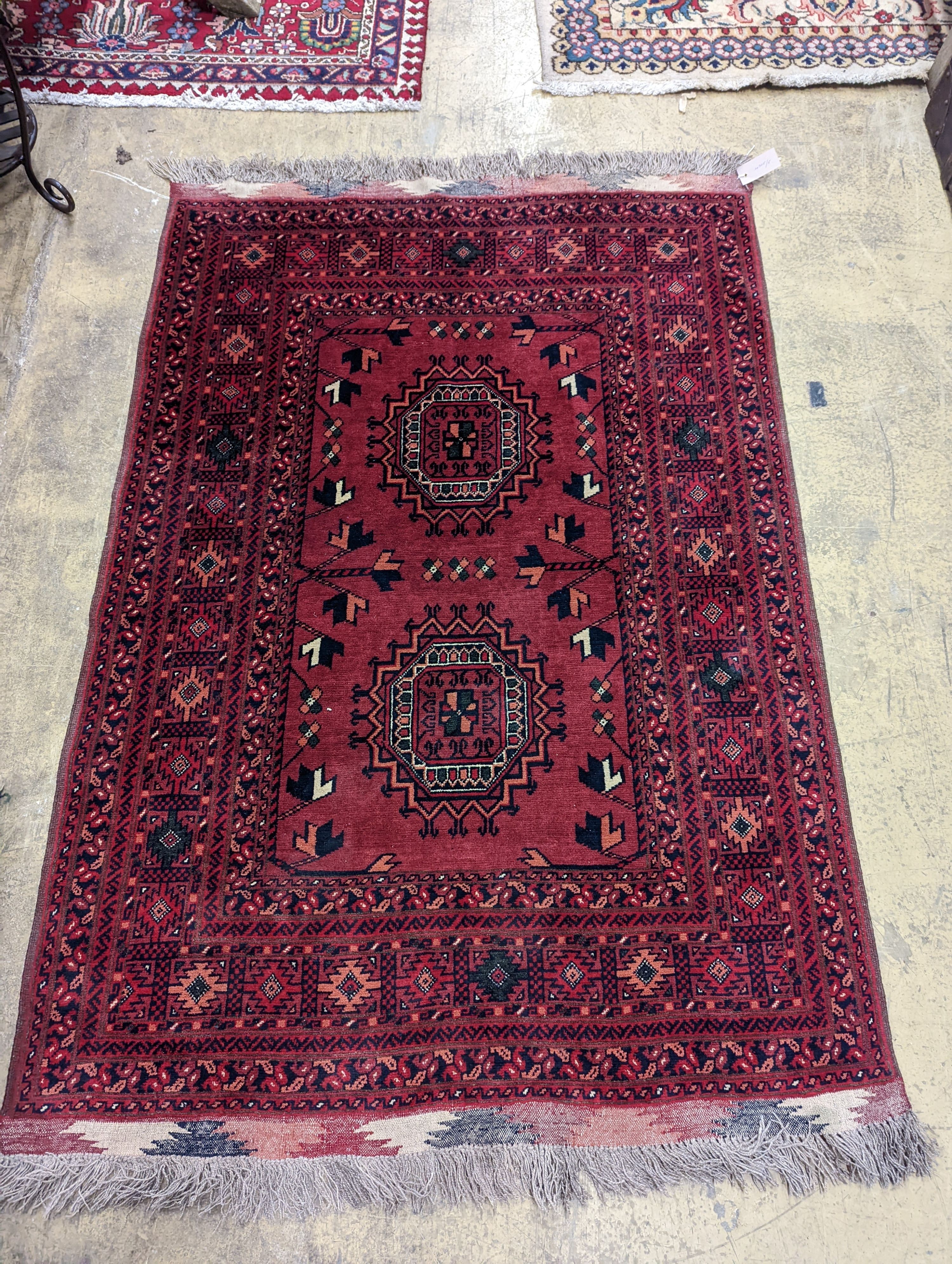A Bokhara burgundy ground rug, 150 x 106cm