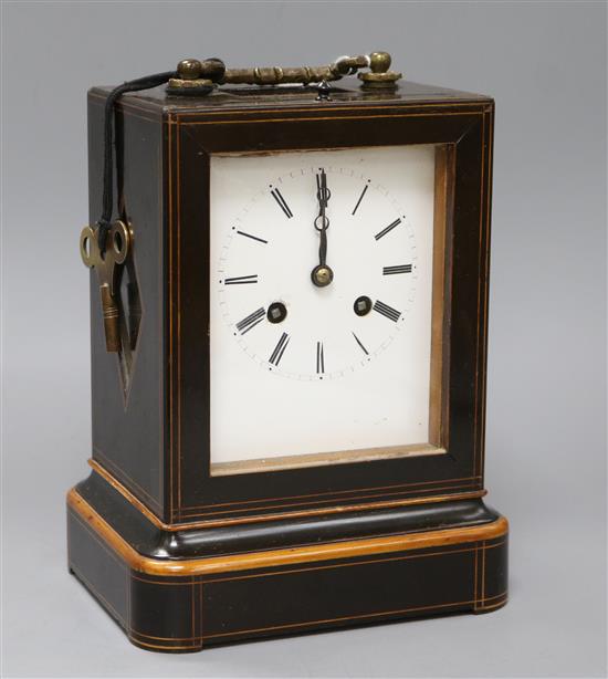 A line-inlaid boxwood and ebonised carriage clock, striking on bell, with white enamelled Roman dial A line-inlaid boxwood and ebonised carriage clock, striking on bell, with white enamelled Roman dial
