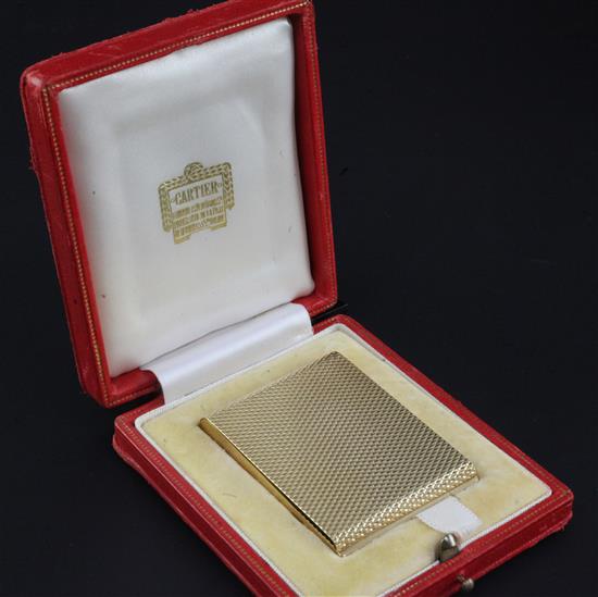 A 1960s Cartier engine turned ribbed 9ct gold matchbook case, 2.25in.
