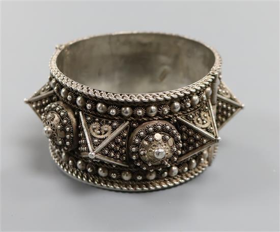 A large Lebanese white metal hinged bangle. A large Lebanese white metal hinged bangle.