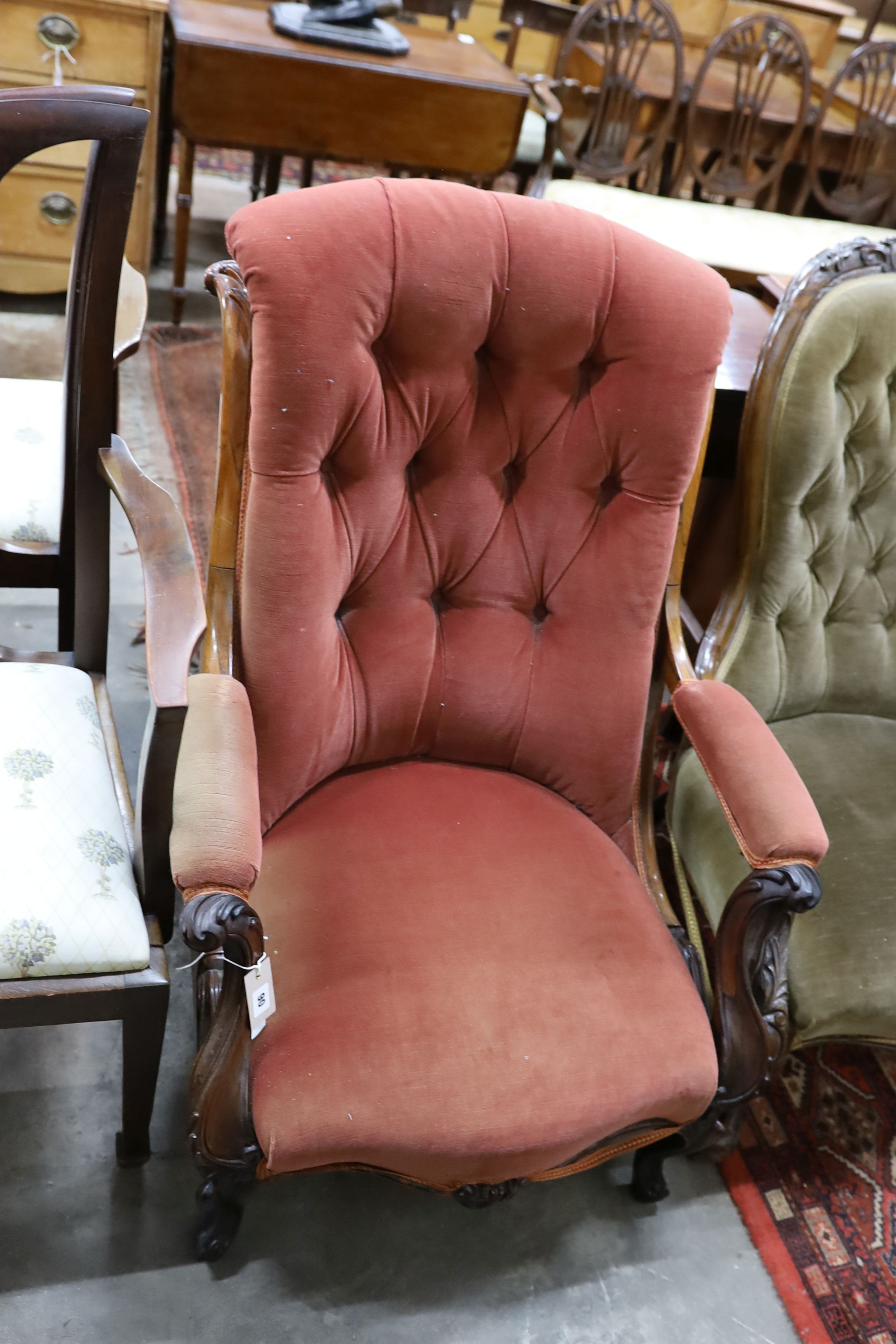 A single Victorian carved rosewood scroll back upholstered open armchair