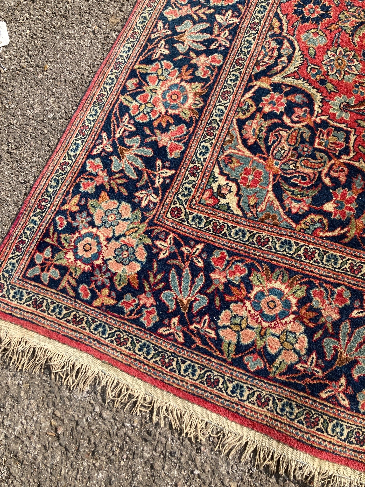 A Kashan red ground rug, with all-over stylised floral motifs