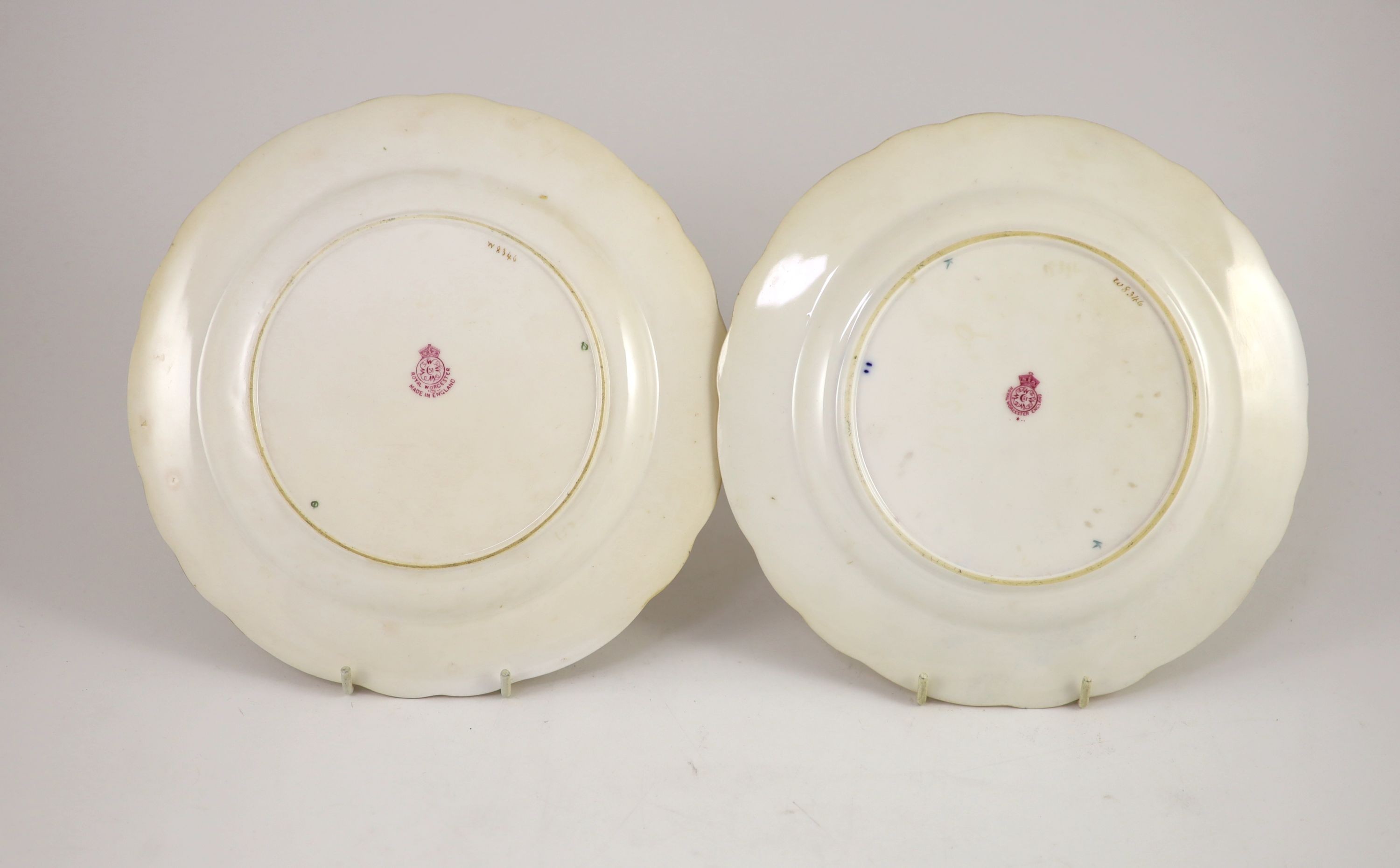 A pair of Royal Worcester fruit painted dessert plates, signed A. Shuck, c.1918 and 1935, cm diameter