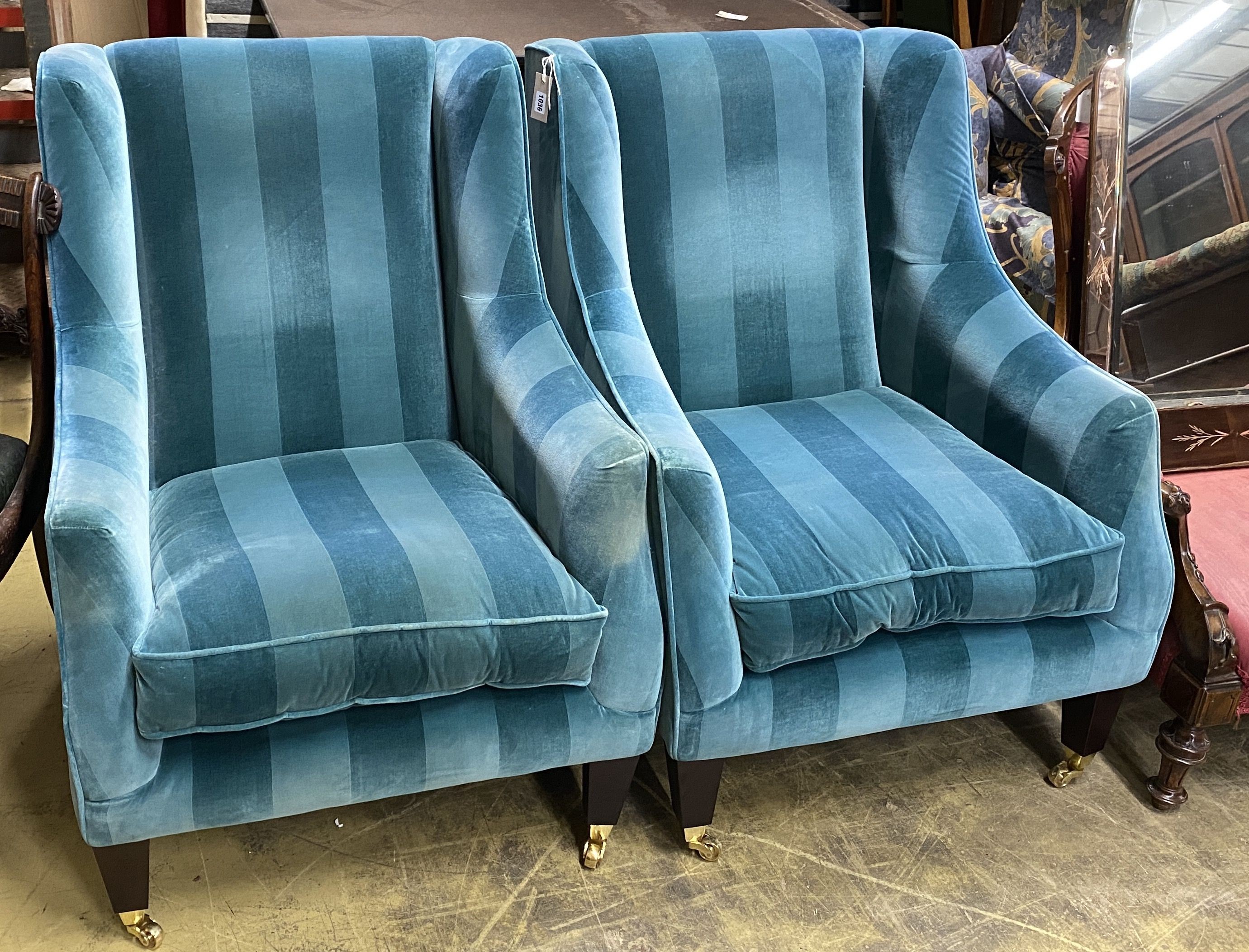 A pair of contemporary upholstered armchairs, width 70cm, depth 86cm, height 97cm