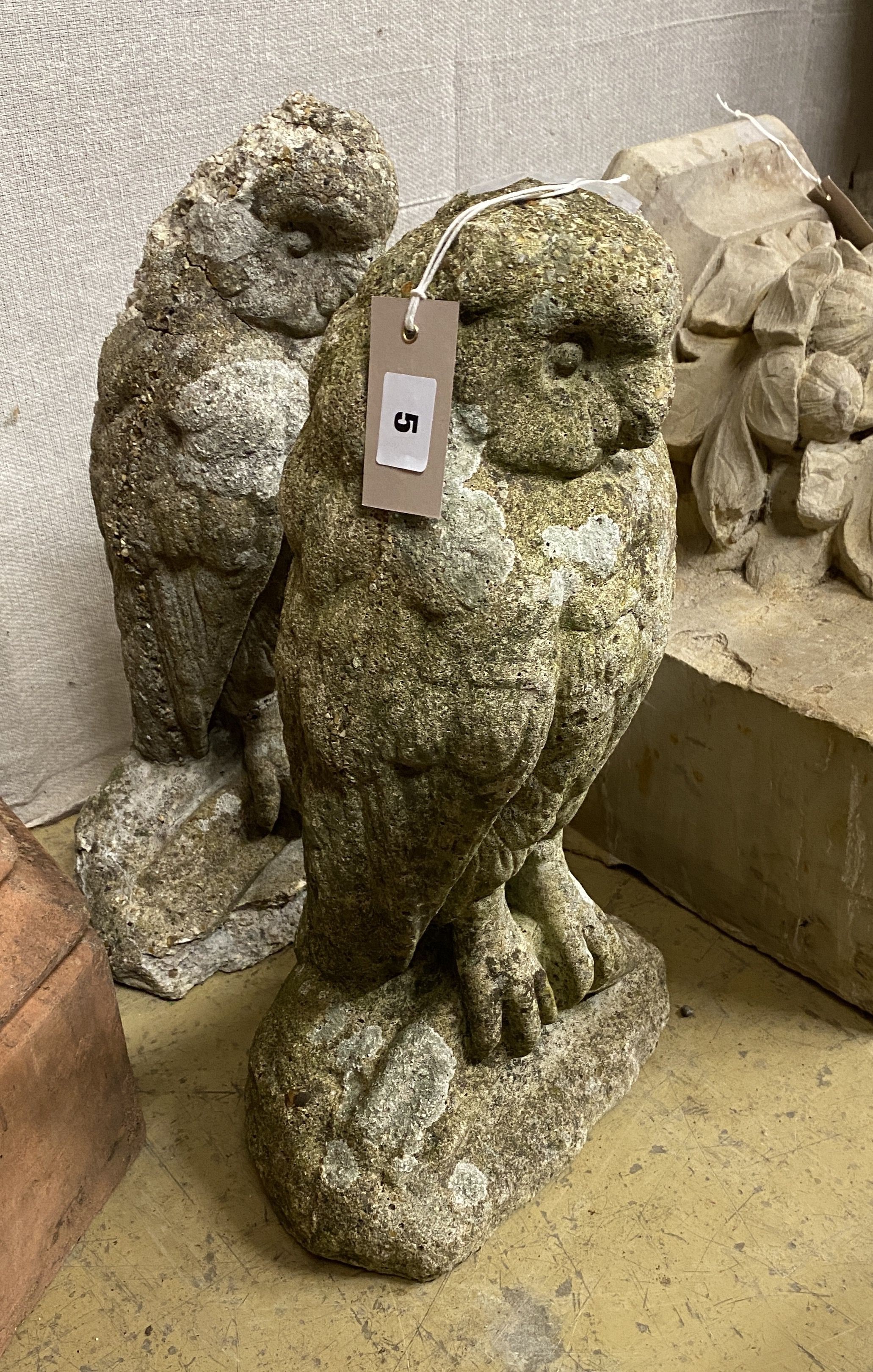 A pair of reconstituted stone owl garden ornaments, height 47cm