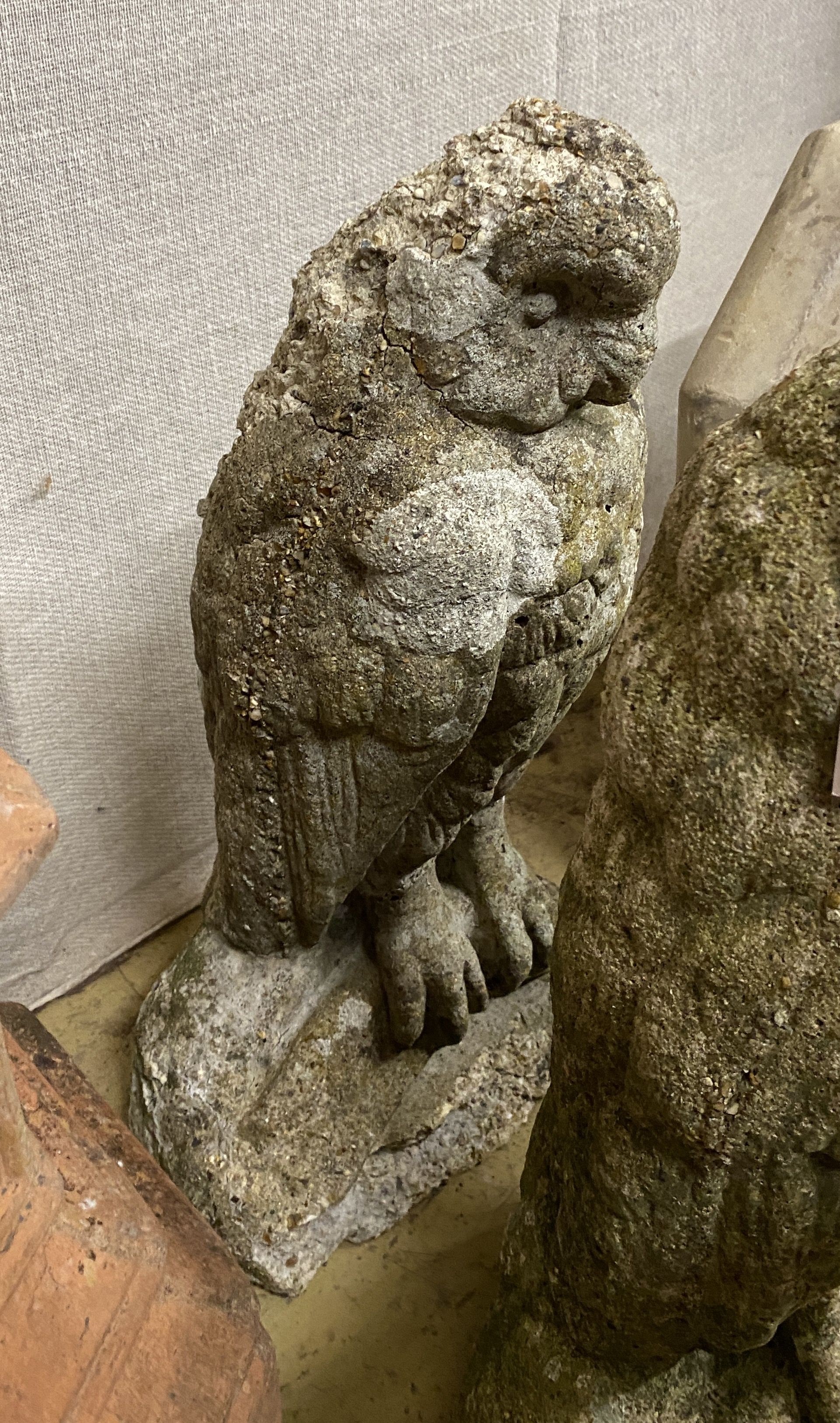 A pair of reconstituted stone owl garden ornaments, height 47cm