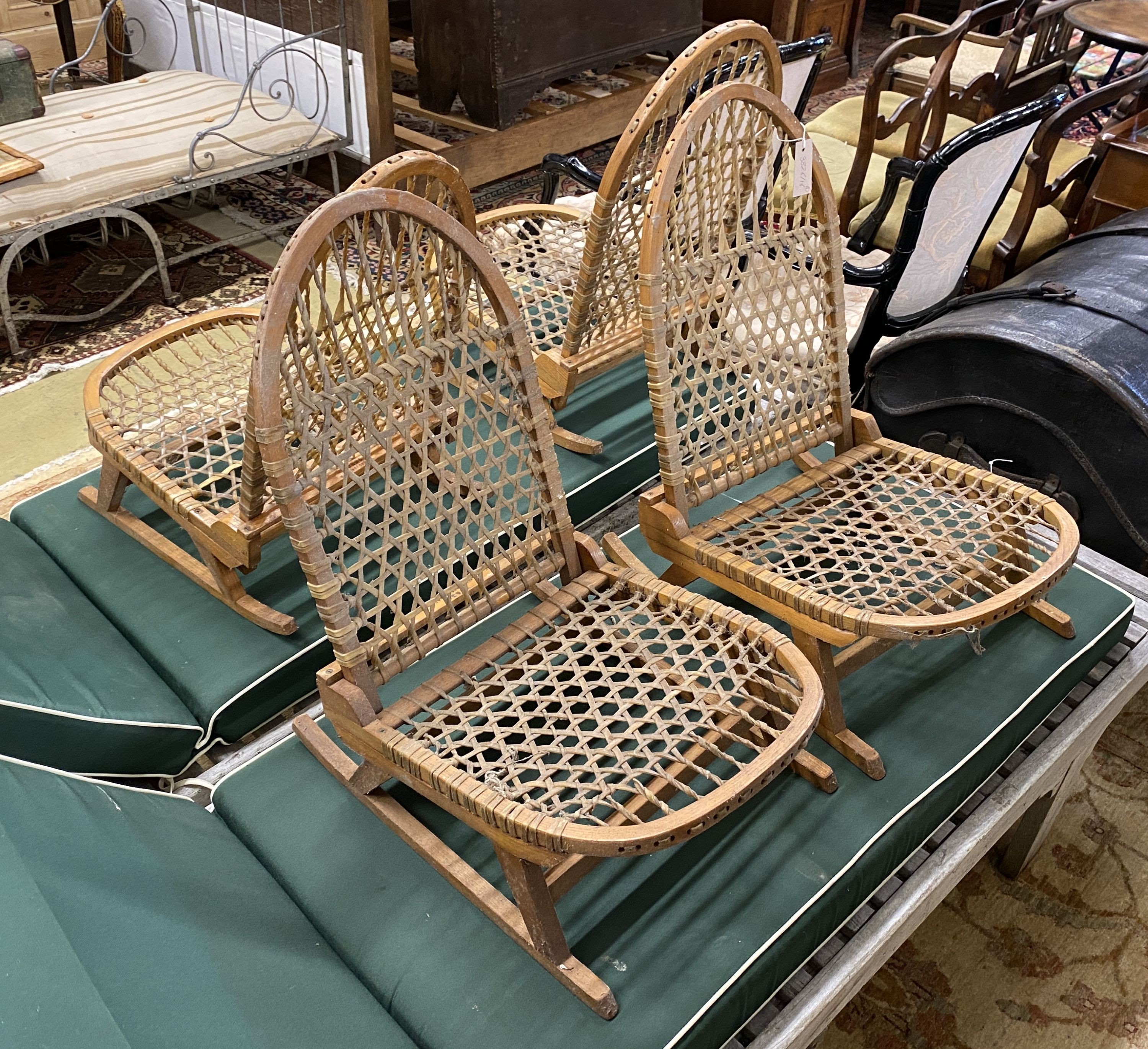 A set of four vintage American bentwood and animal gut folding canoe seats by Tubbs of Wallingford, width 40cm, depth 52cm, height 60cm