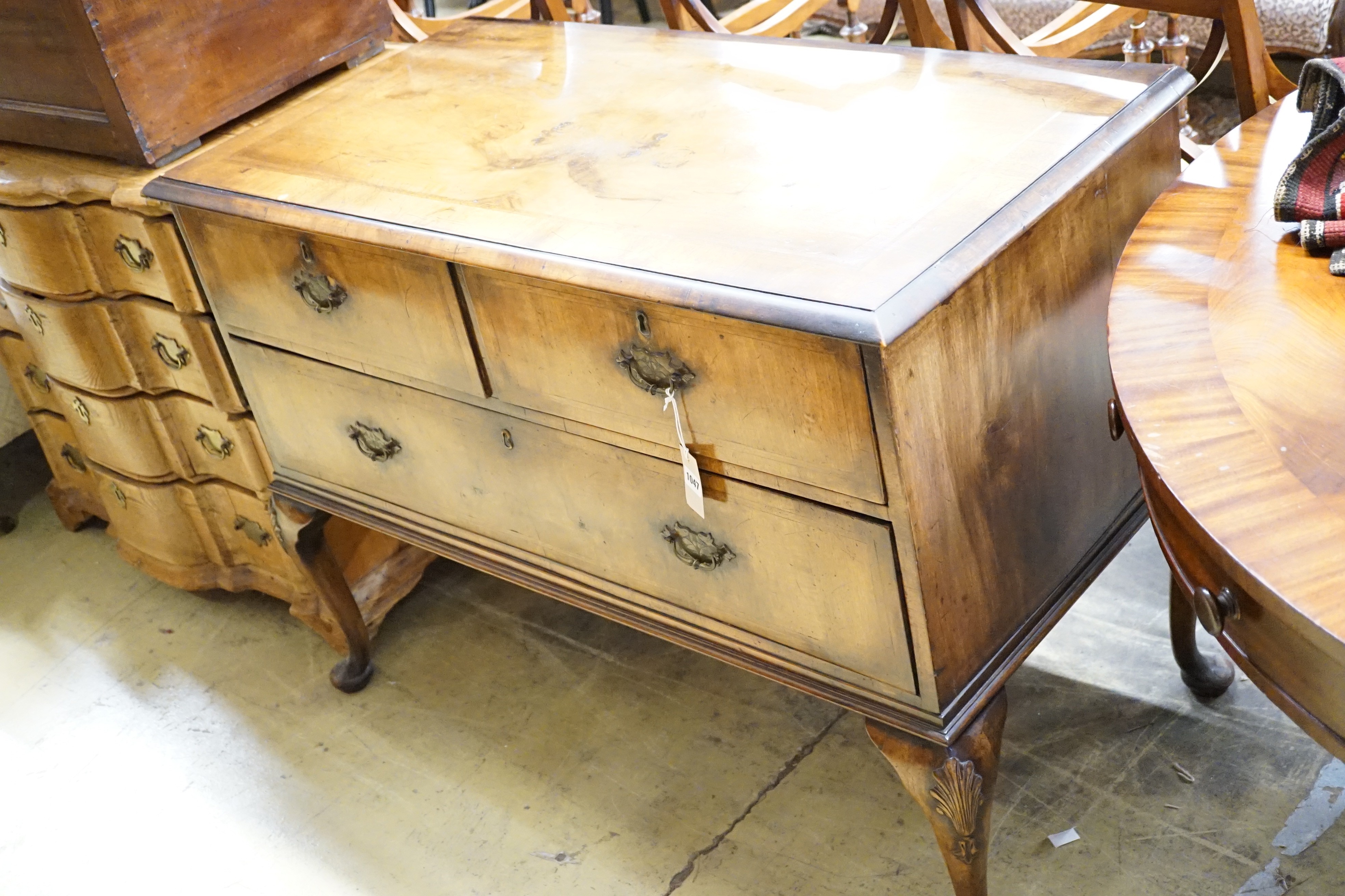 A Queen Anne style walnut chest of three drawers on cabriole legs, width 111cm, depth 56cm, height 83cm