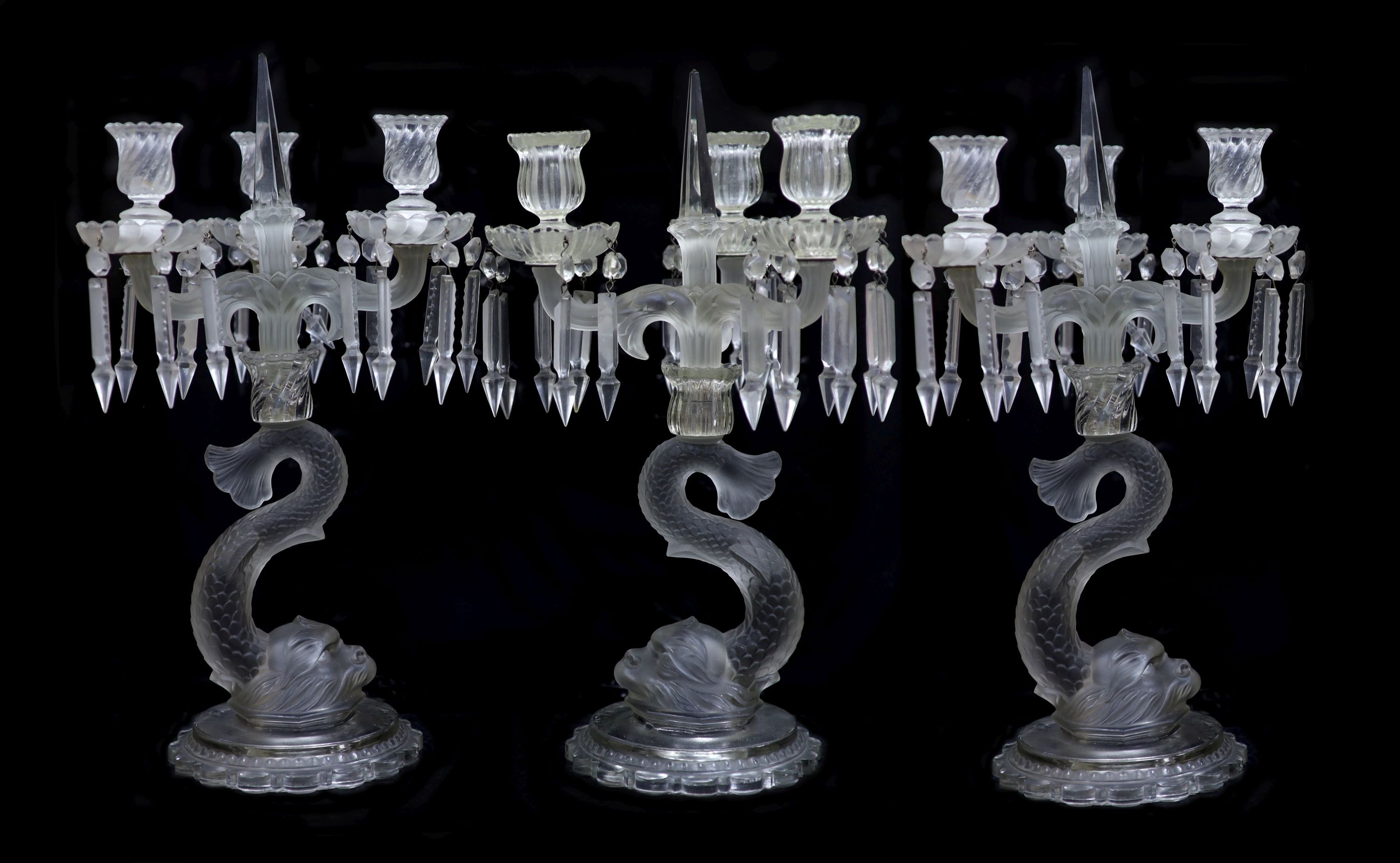 A pair of Baccarat moulded and frosted glass candelabra and another similar, late 19th century, 47 and 48.5cm high (3)