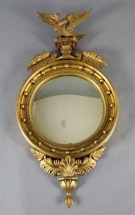 A William IV giltwood and gesso convex wall mirror, W.1ft 10in. H.3ft 5in. A William IV giltwood and gesso convex wall mirror, W.1ft 10in. H.3ft 5in.