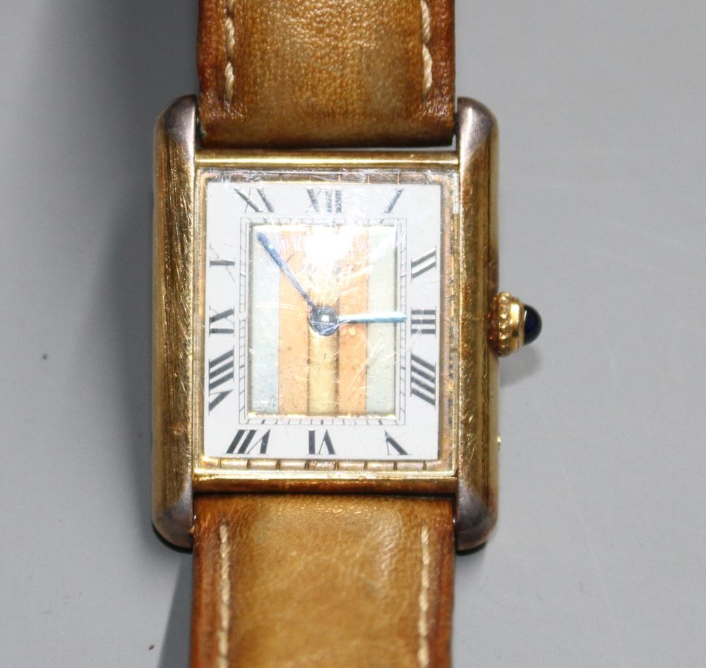 A ladys 925 gilt Must de Cartier Vermeil Tank quartz wrist watch, on associated strap.