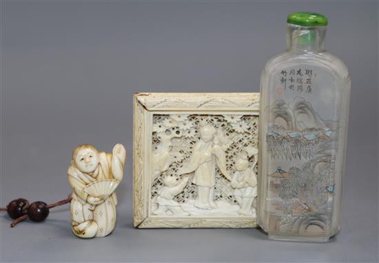 A Chinese ivory tangram puzzle, an ivory netsuke and a pressed amber rhino A Chinese ivory tangram puzzle, an ivory netsuke and a pressed amber rhino
