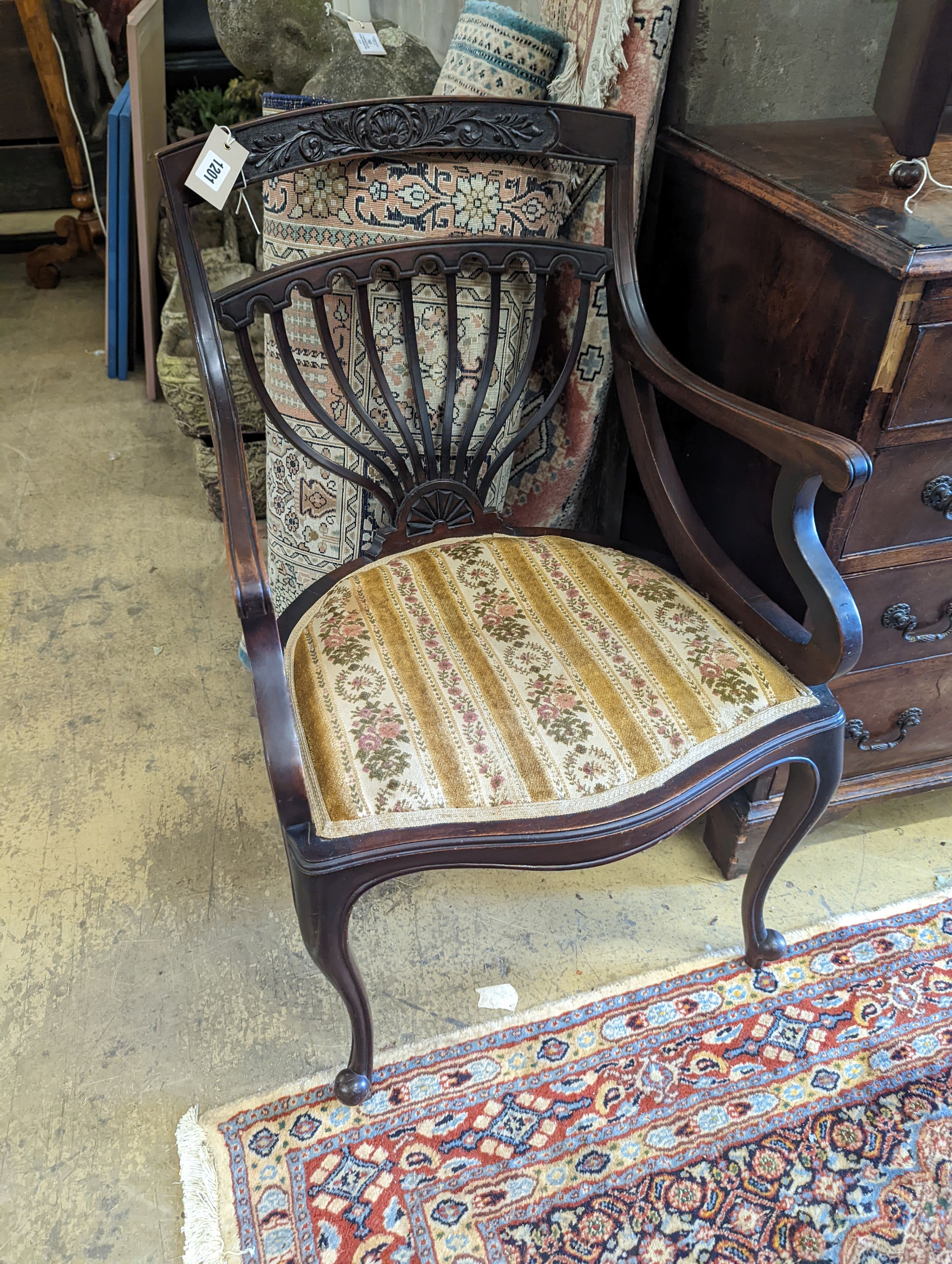 A late Victorian carved mahogany elbow chair