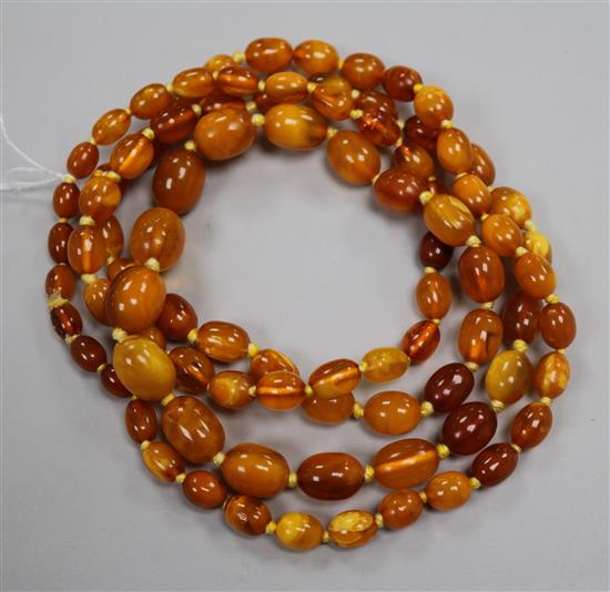 A single strand graduated amber bead necklace, gross weight 72 grams, 128cm. A single strand graduated amber bead necklace, gross weight 72 grams, 128cm.