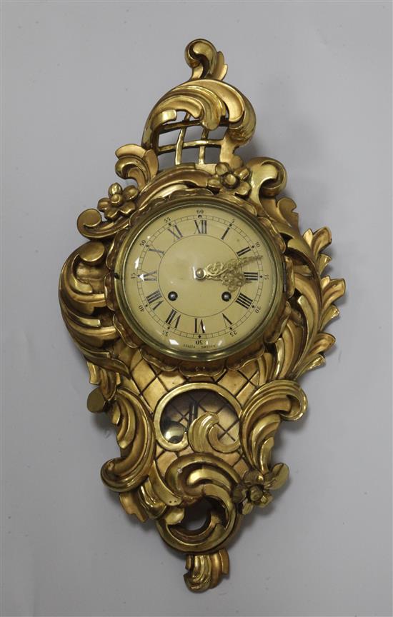 A 20th century Swedish giltwood cartel wall clock, height 23in.