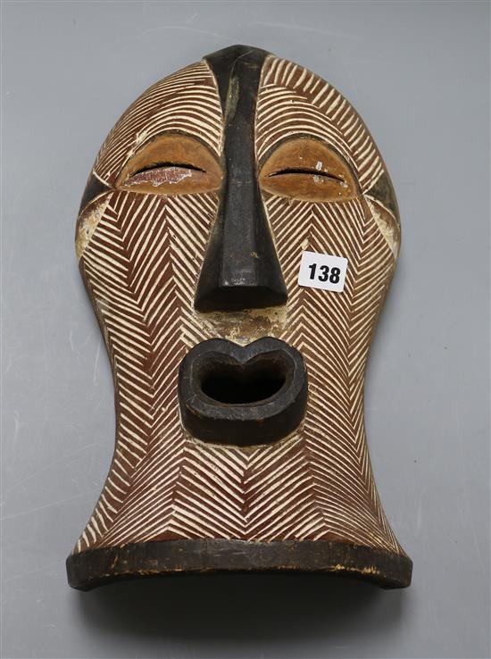 A Songye carved wood mask length 37cm