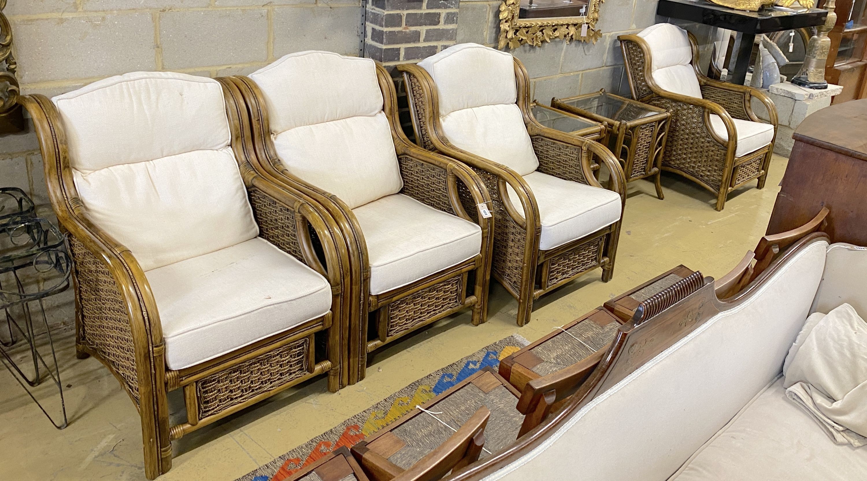 A caned bamboo six piece conservatory suite comprising four armchairs with loose cushions, width 68cm, depth 90cm, height 93cm and two side tables