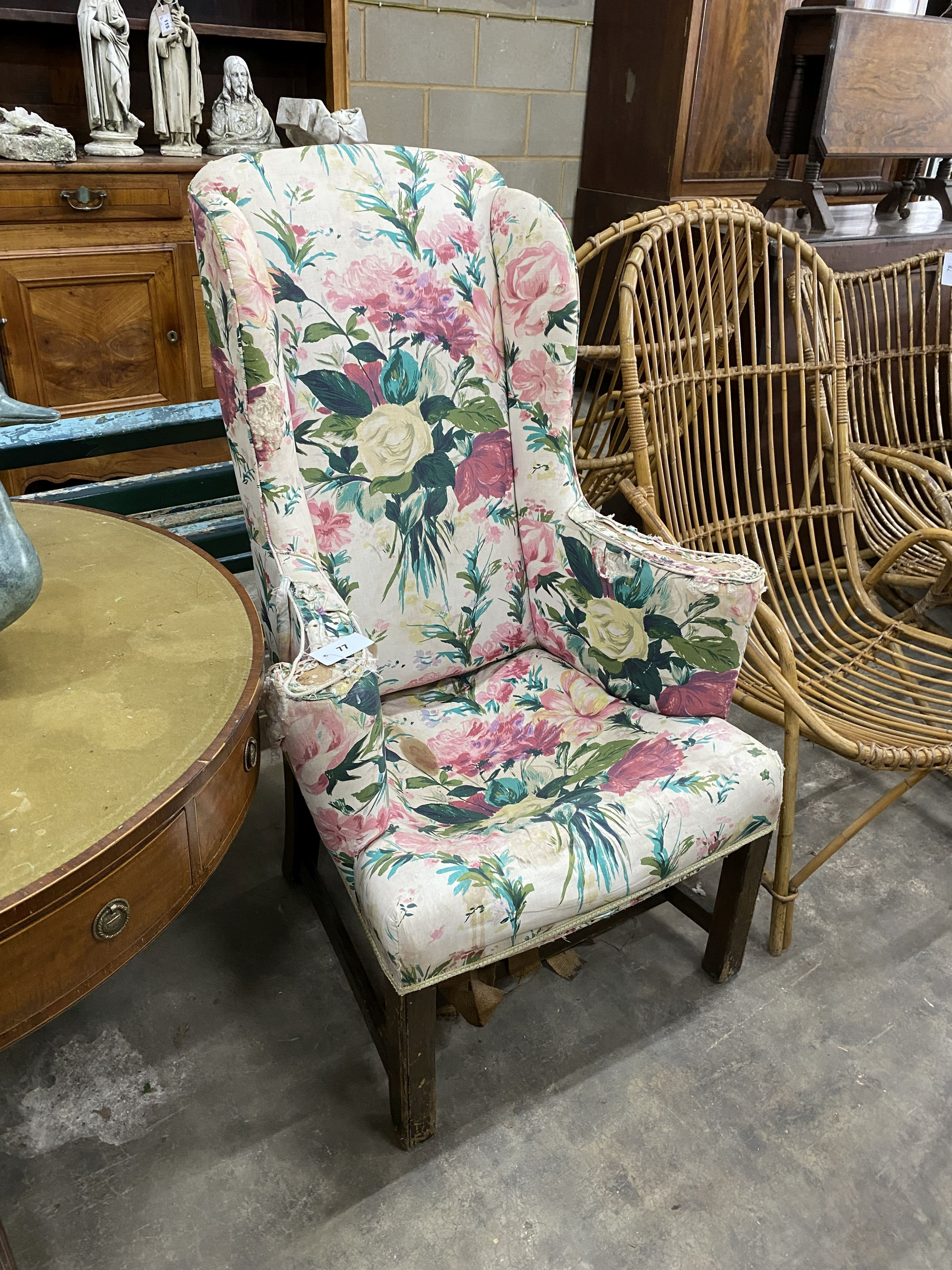 A George III provincial upholstered wing armchair, width 71cm, depth 70cm, height 110cm