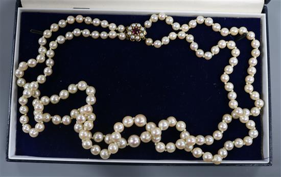 A double string graduated cultured pearl necklace with 9ct gold, pearl and gem set clasp, 52cm. A double string graduated cultured pearl necklace with 9ct gold, pearl and gem set clasp, 52cm.