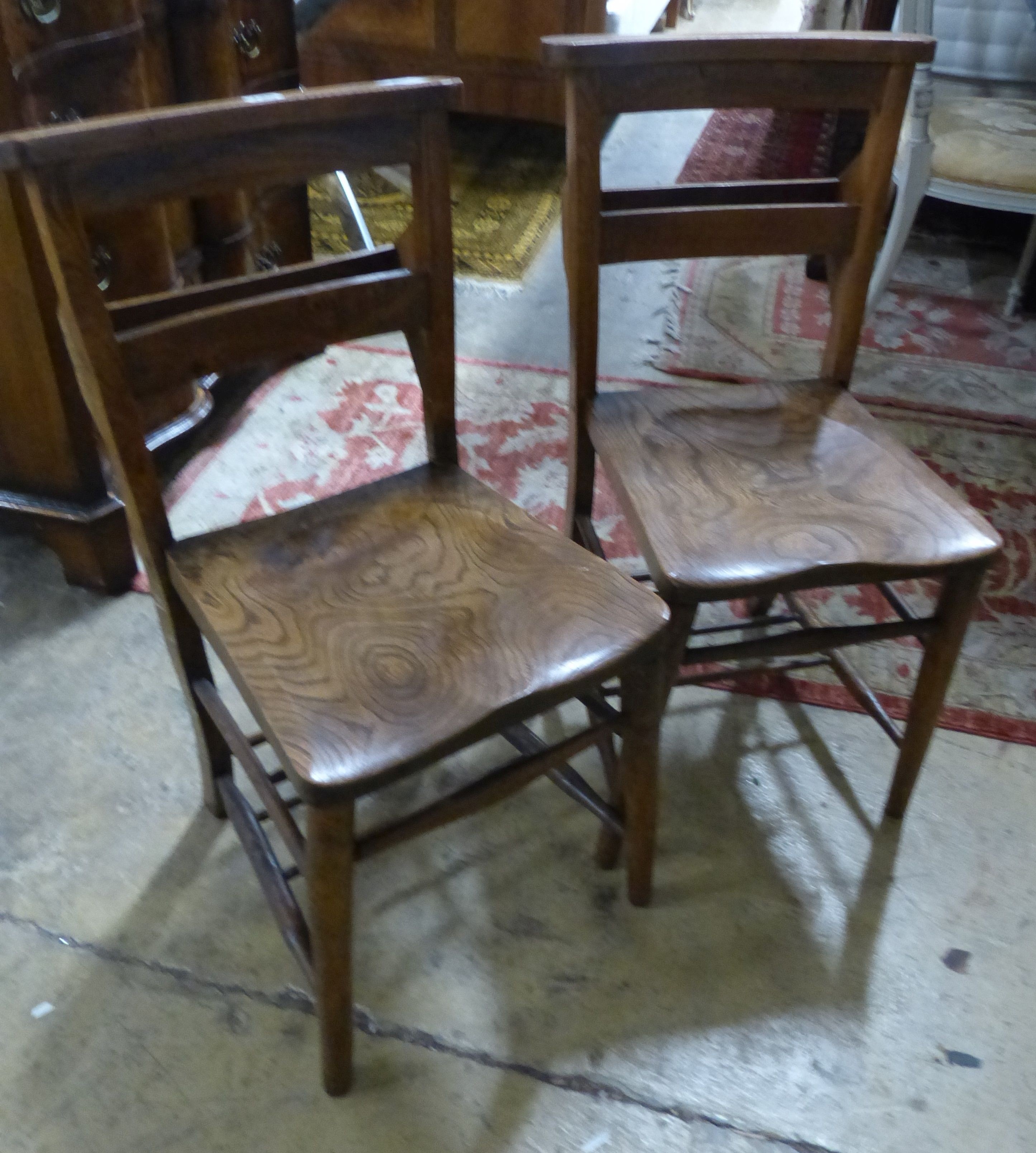 A set of four Victorian elm chapel chairs