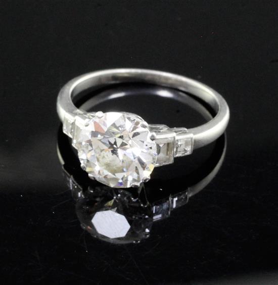 A mid 20th century single stone diamond ring, with graduated diamond set shoulders and diamond set setting, size N.