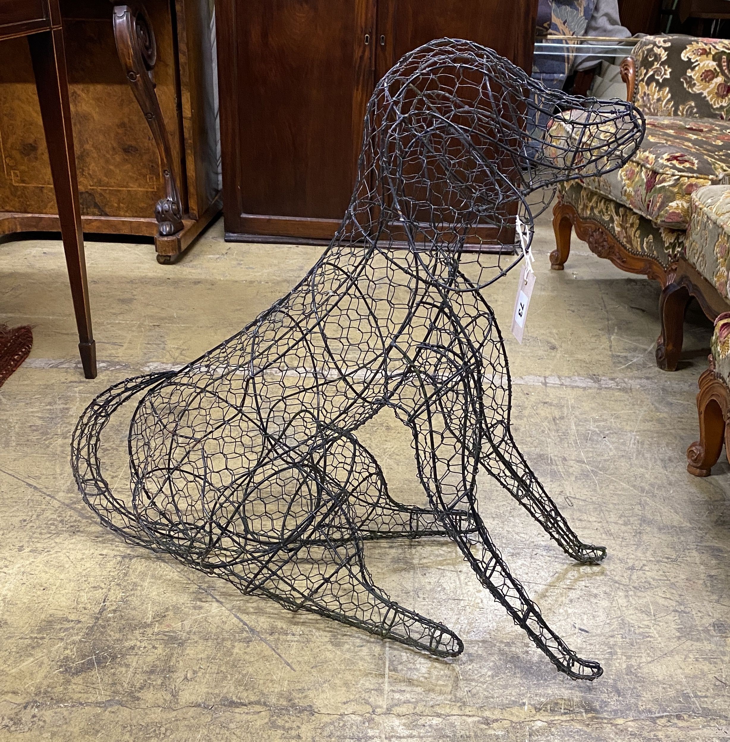 A wirework seated dog garden ornament, height 70cm