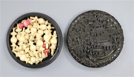 A 19th century Chinese export tortoiseshell circular box containing ivory gaming pieces A 19th century Chinese export tortoiseshell circular box containing ivory gaming pieces