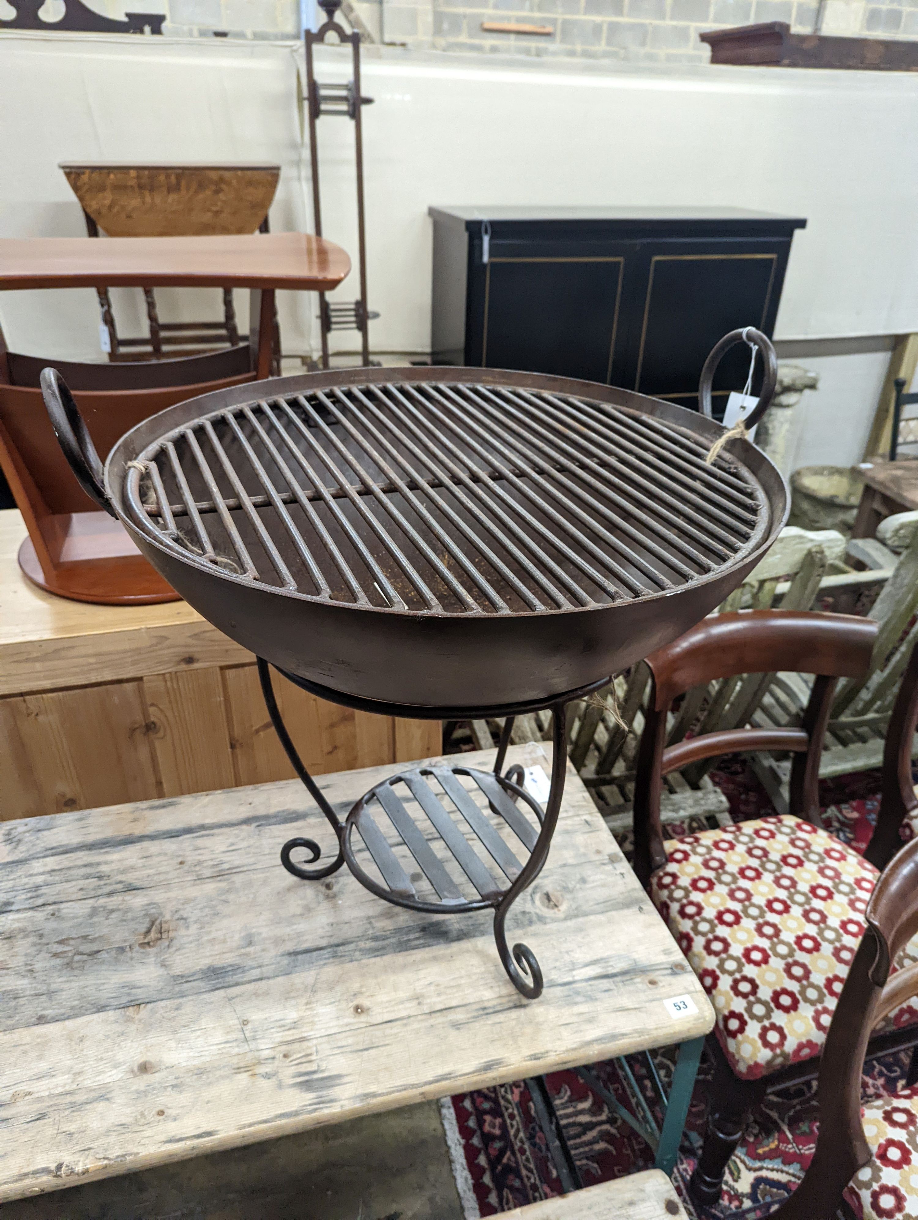A circular wrought iron fire pit on stand, diameter 62cm, height 66cm