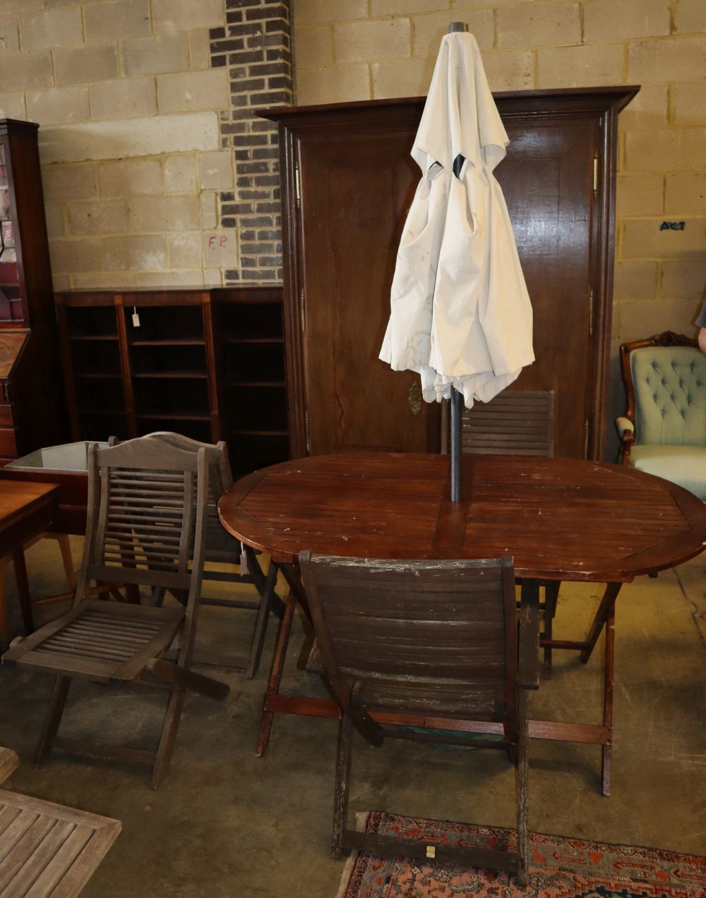 A folding teak garden table, W.148cm, D.90cm, H.74cm, four folding