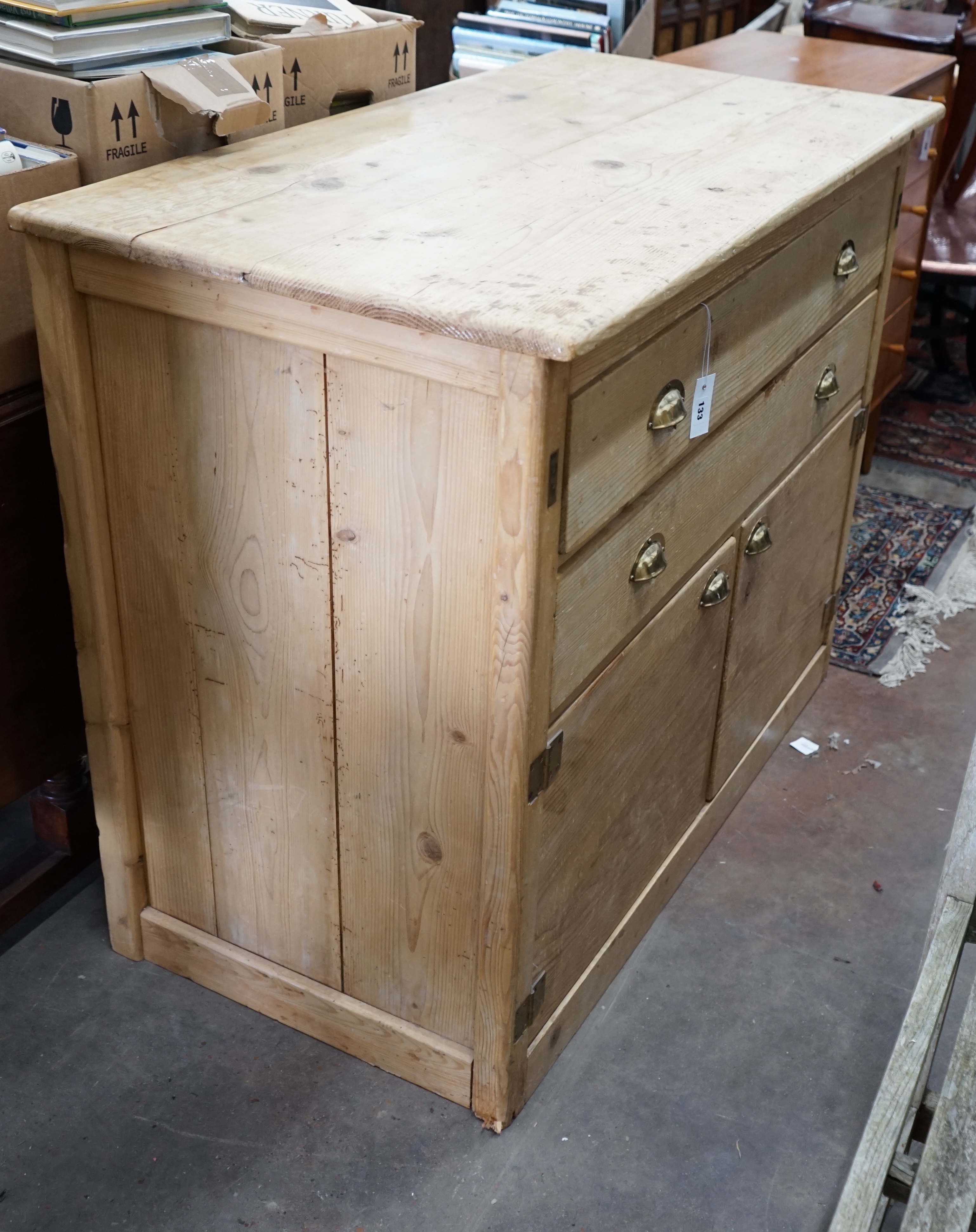 A 19th century pine two drawer side cabinet, width 124cm depth 63cm height 100cm