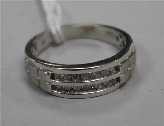 A modern 10ct white gold and two row channel set diamond half hoop ring, size W. A modern 10ct white gold and two row channel set diamond half hoop ring, size W.